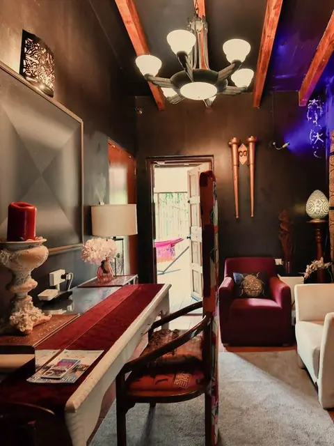 The Black Velvet room, dark walls and a chandelier